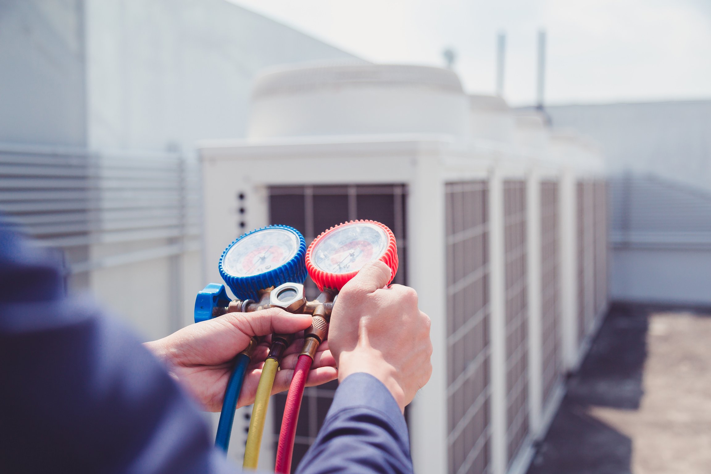 Technician is checking air conditioner ,measuring equipment for filling air conditioners.